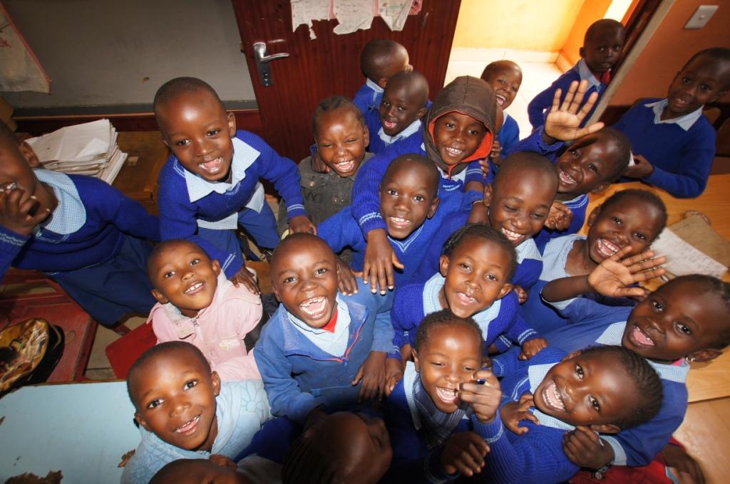 bellissimi bambini sorridenti in grembiulino blu in una scuola ripresi dall'alto